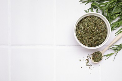 Photo of Dry and fresh tarragon on white tiled table, flat lay. Space for text
