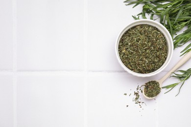 Dry and fresh tarragon on white tiled table, flat lay. Space for text