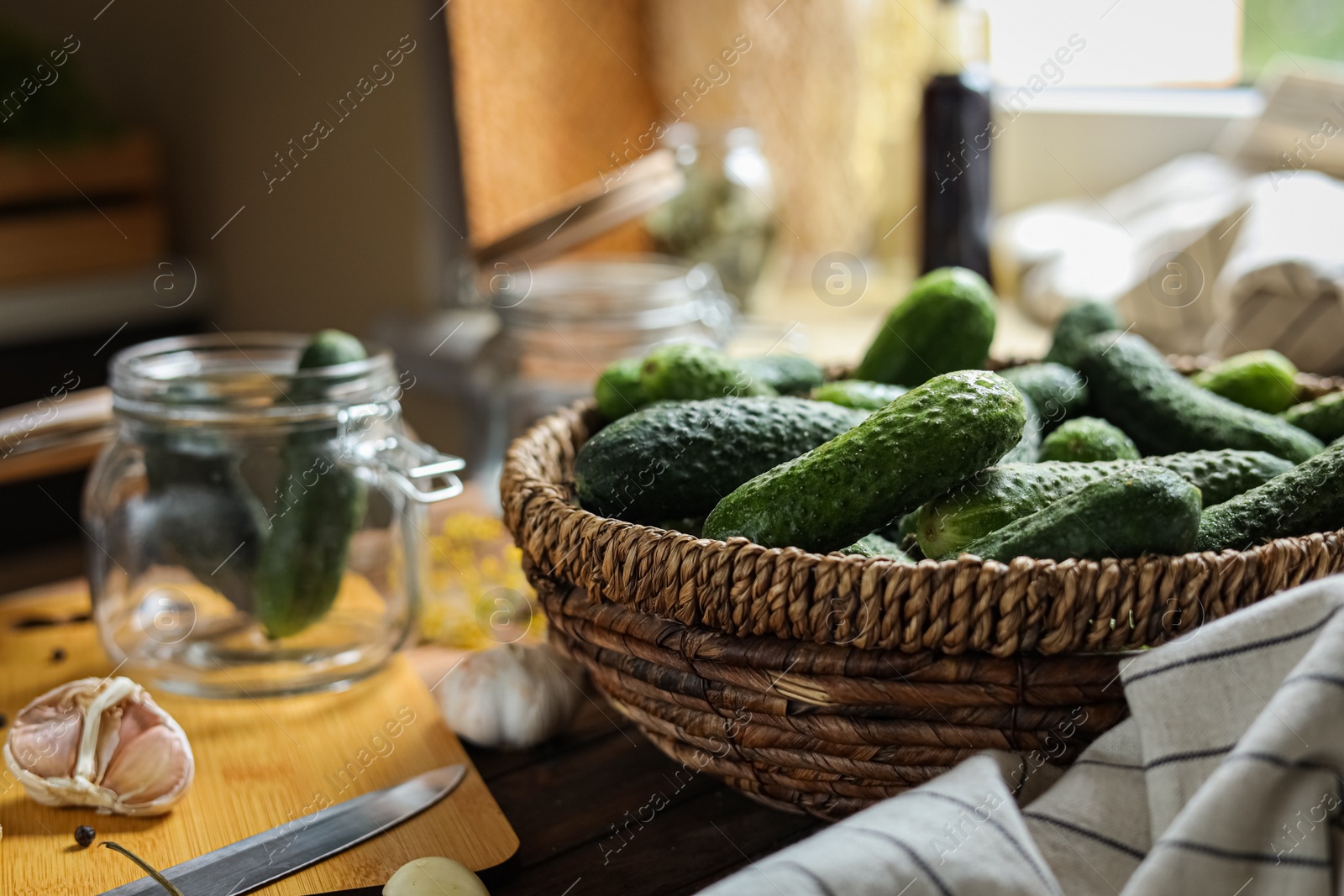 Photo of Fresh cucumbers and other ingredients on wooden table, closeup with space for text. Pickling vegetables