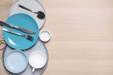 Flat lay composition with beautiful dishware on wooden table. Space for text