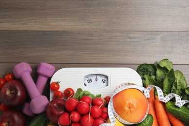 Photo of Flat lay composition with scales and healthy food on wooden table, space for text