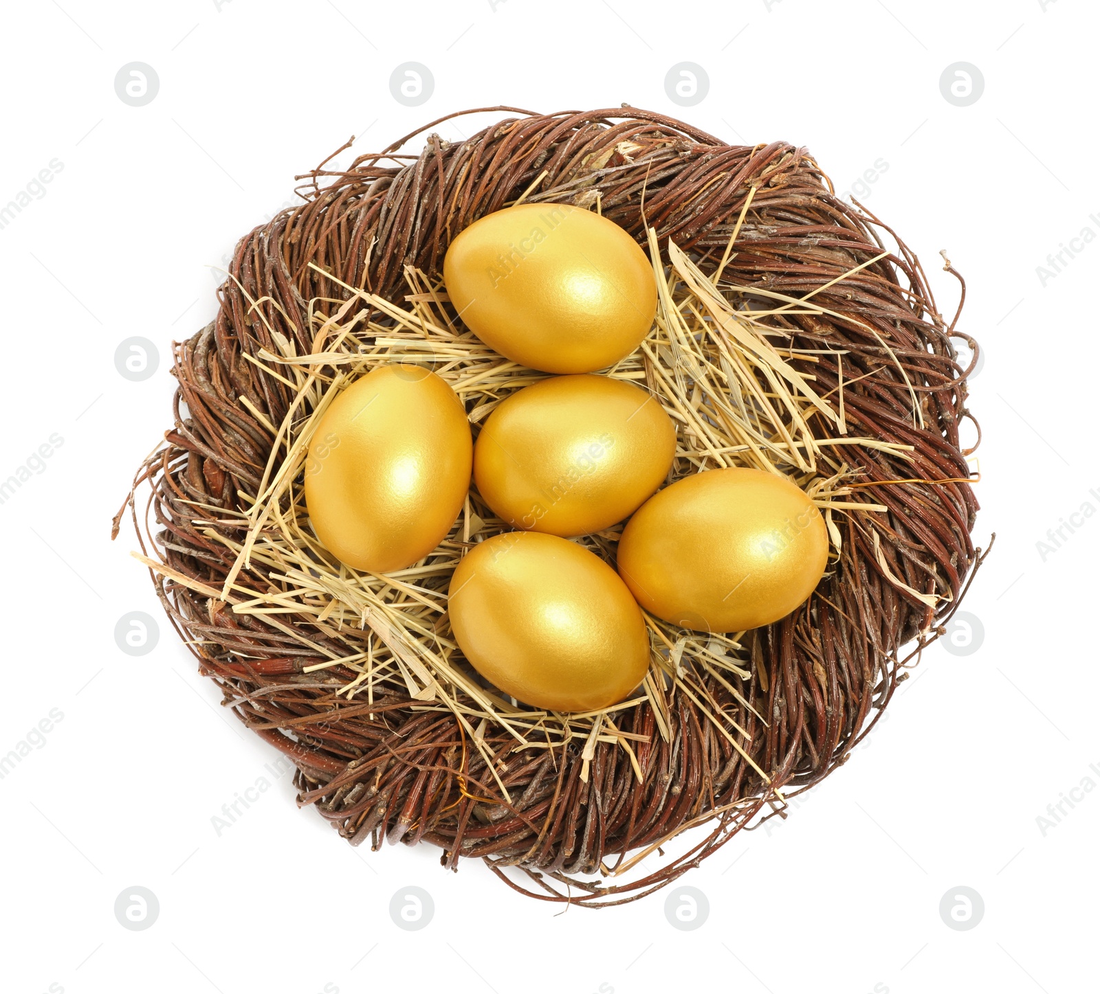 Photo of Shiny golden eggs in nest on white background, top view