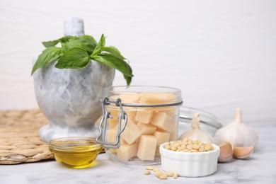 Photo of Different ingredients for cooking tasty pesto sauce on white marble table