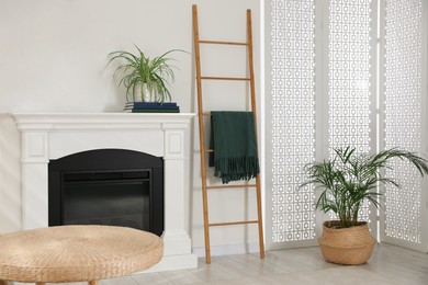 Photo of Wooden ladder near fireplace in stylish room