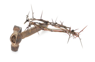 Photo of Crown of thorns and hammer on white background. Easter attributes