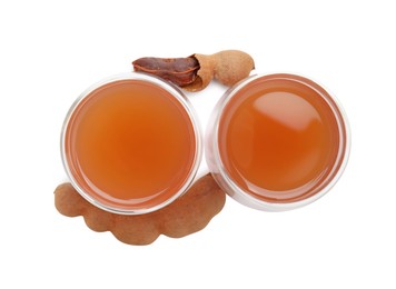 Photo of Glasses of tamarind juice and fresh fruits isolated on white, top view