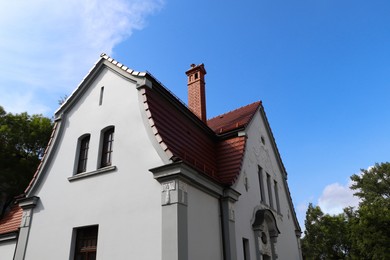 Beautiful house with brown roof against blue sky