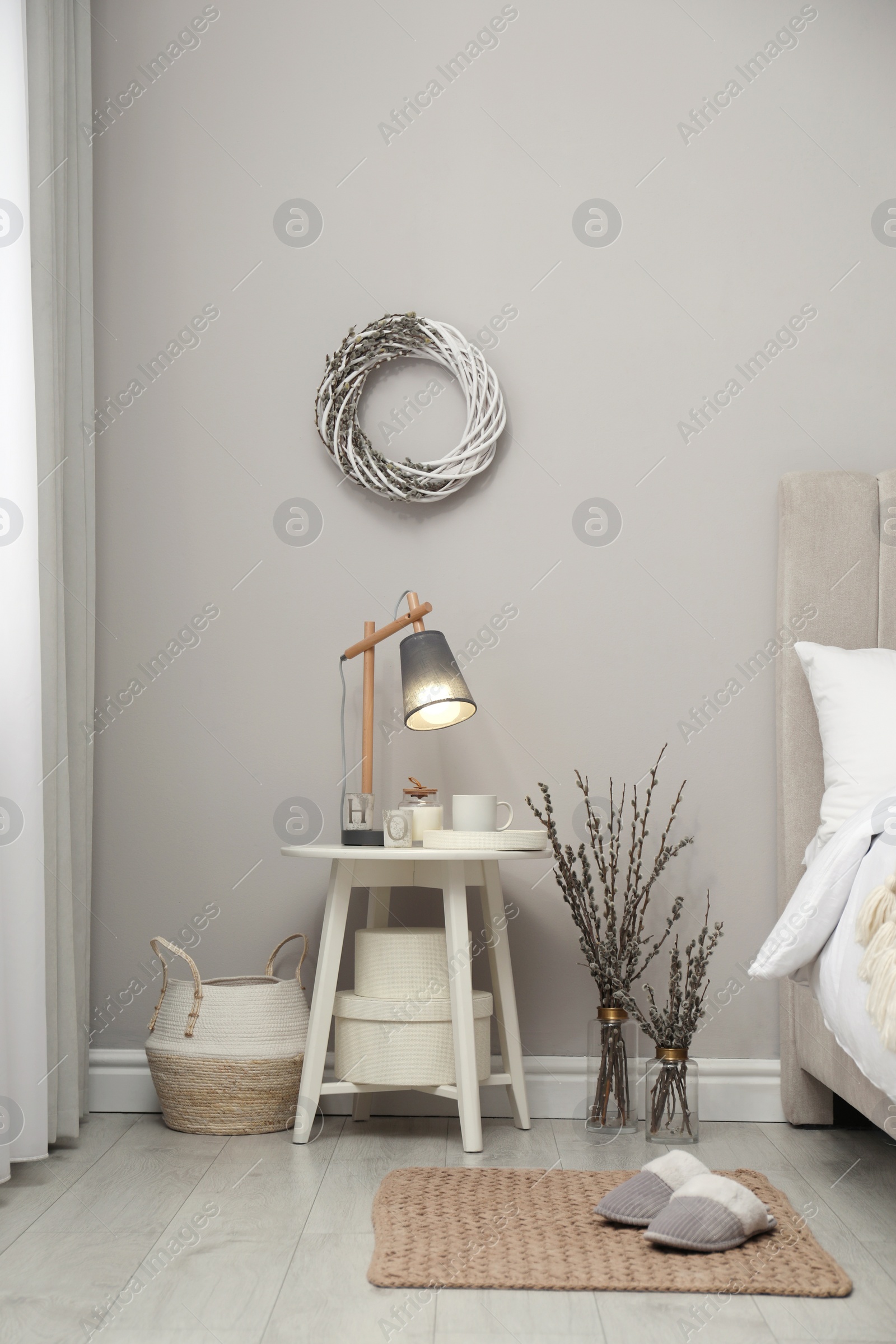 Photo of Bedroom interior with pussy willow branches and other decor
