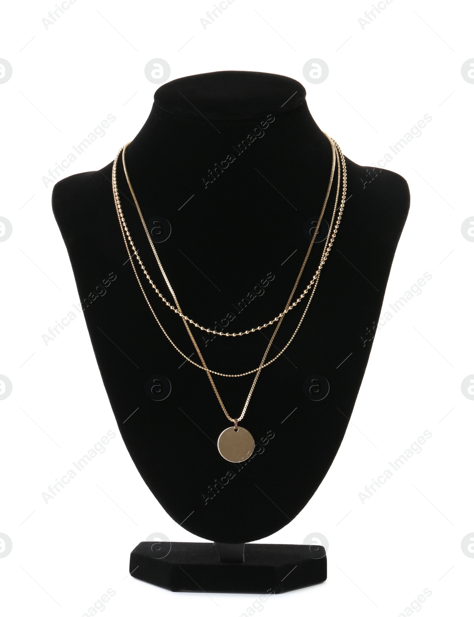 Photo of Stylish golden necklace on jewelry bust against white background