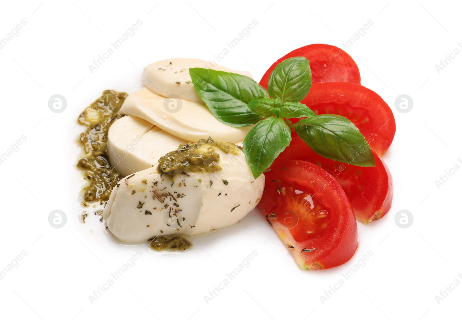 Photo of Tasty salad Caprese with mozzarella, tomatoes, basil and pesto sauce isolated on white