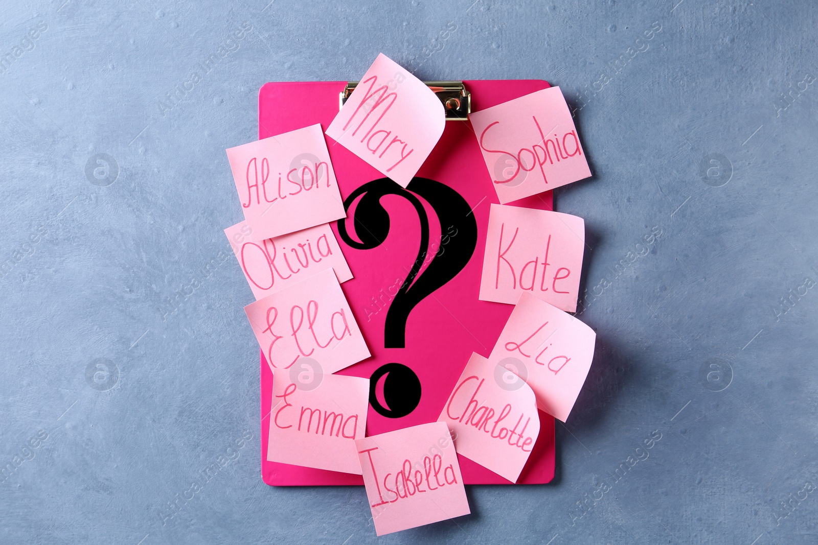 Photo of Question mark and paper notes with different baby names on blue background, top view