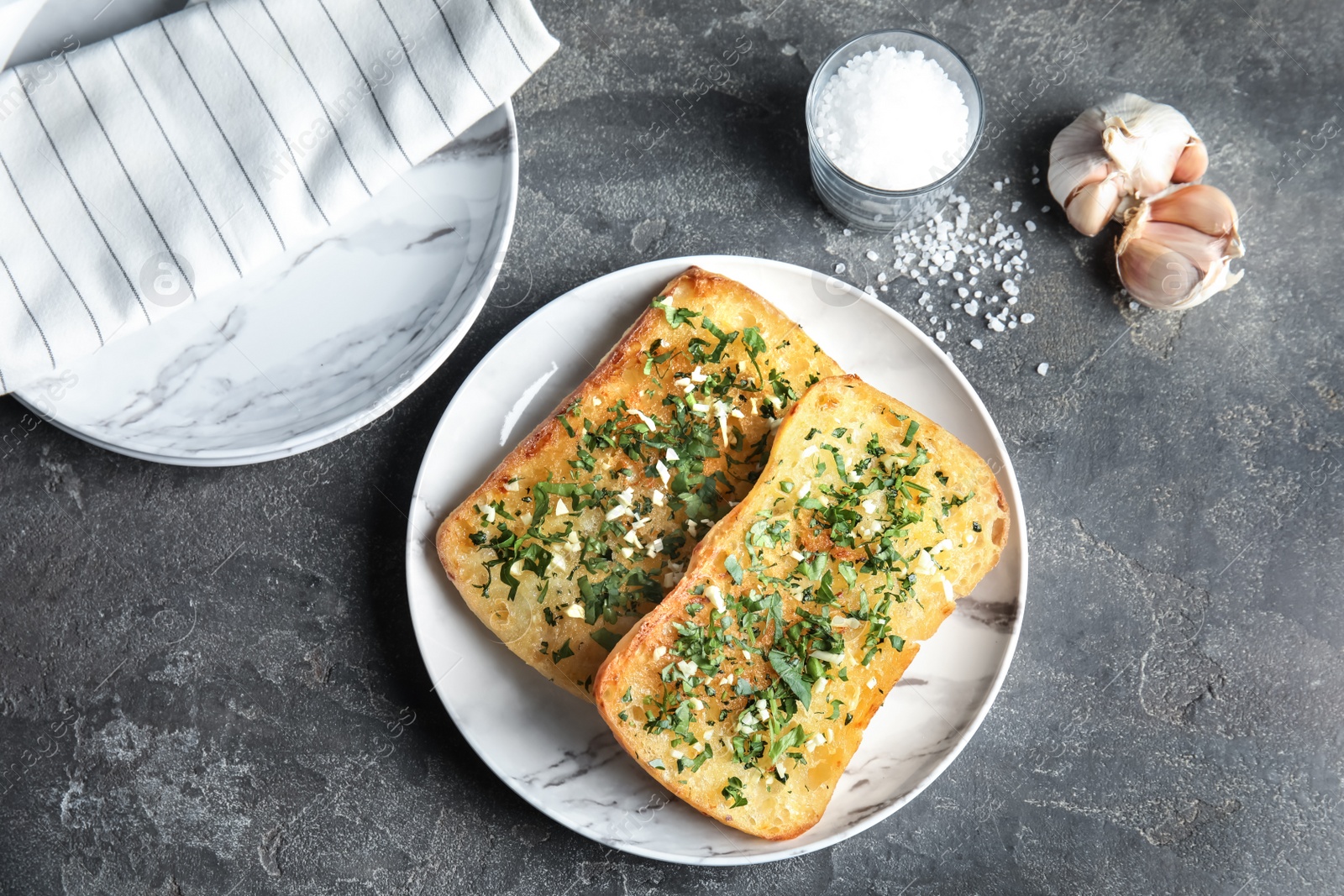 Photo of Flat lay composition with tasty homemade garlic bread on table