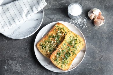 Photo of Flat lay composition with tasty homemade garlic bread on table