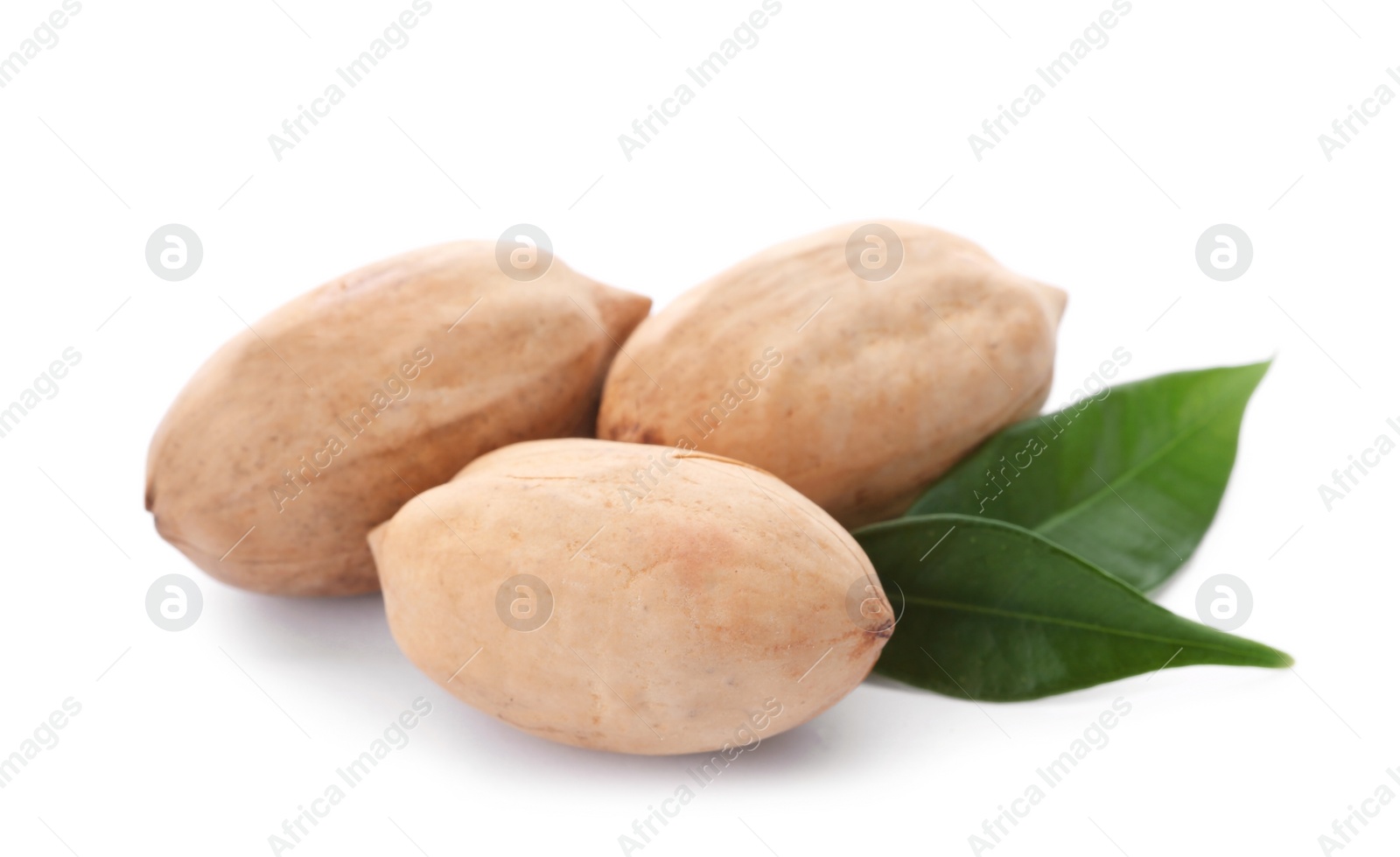 Photo of Pecan nuts in shell and leaves on white background. Nutritive food