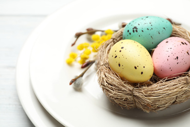 Photo of Festive Easter table setting with quail eggs on white background, closeup