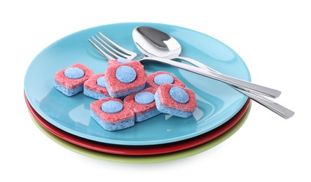 Photo of Dishware with many dishwasher detergent tablets on white background