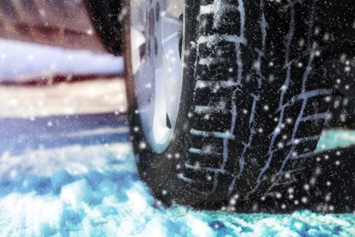 Image of Car with winter tires on snowy road, closeup view