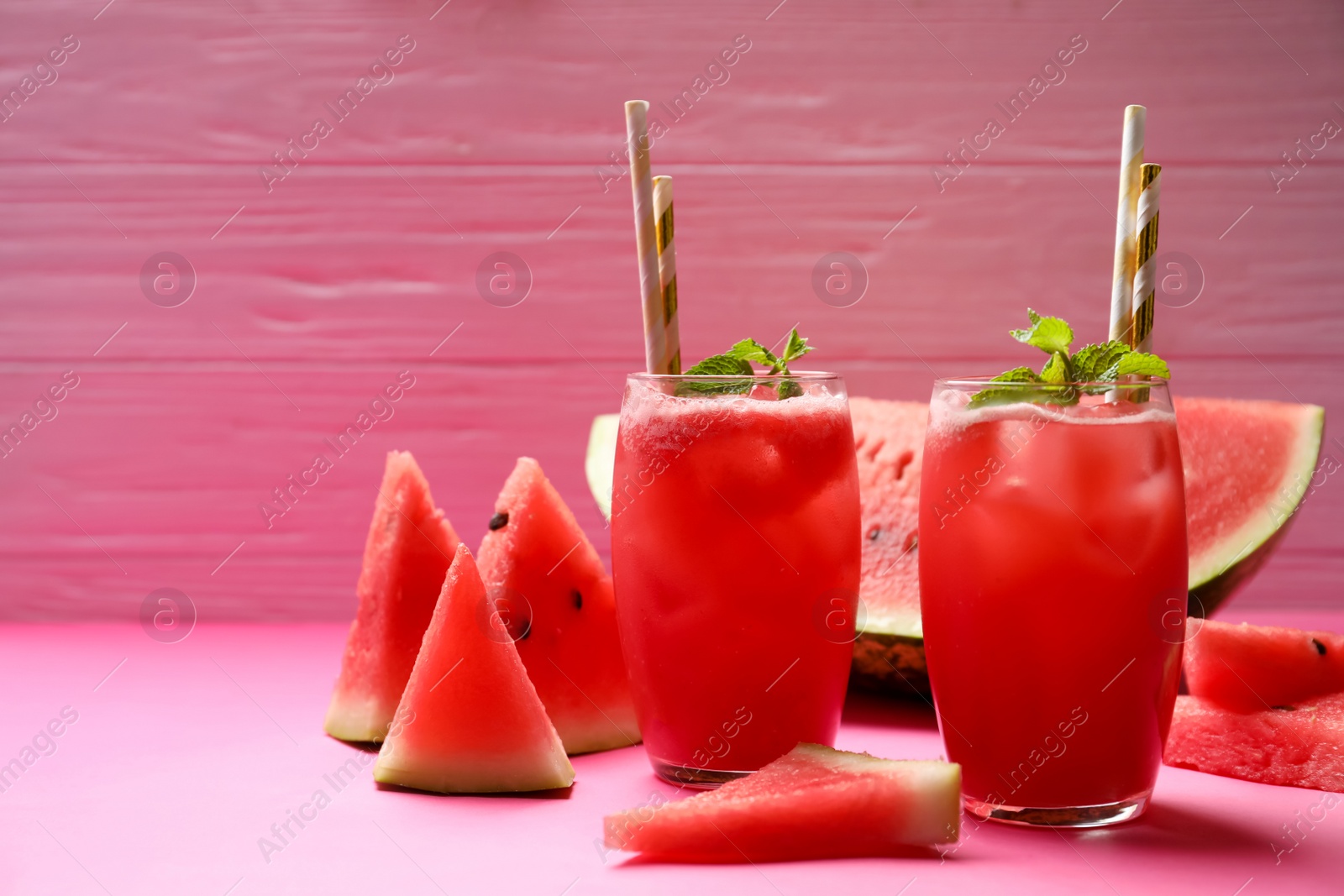 Photo of Tasty watermelon drink with mint on pink background