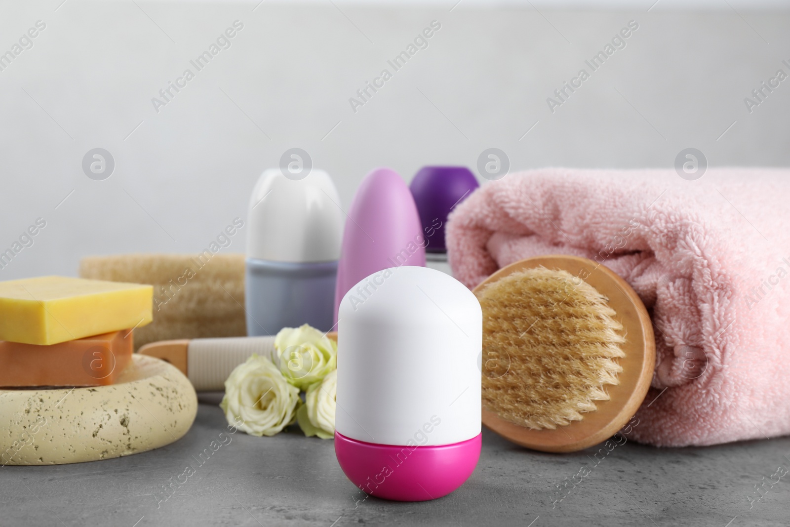 Photo of Composition with natural roll-on deodorants on grey marble table