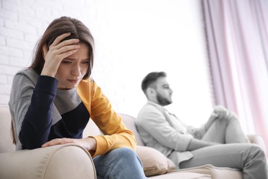 Image of Unhappy young couple with relationship problems at home, focus on woman. Cheating and breakup