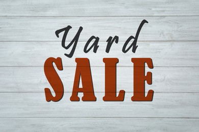 Image of Words Yard Sale on white wooden surface, top view