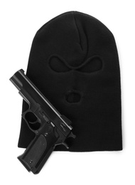 Photo of Black knitted balaclava and pistol on white background, top view