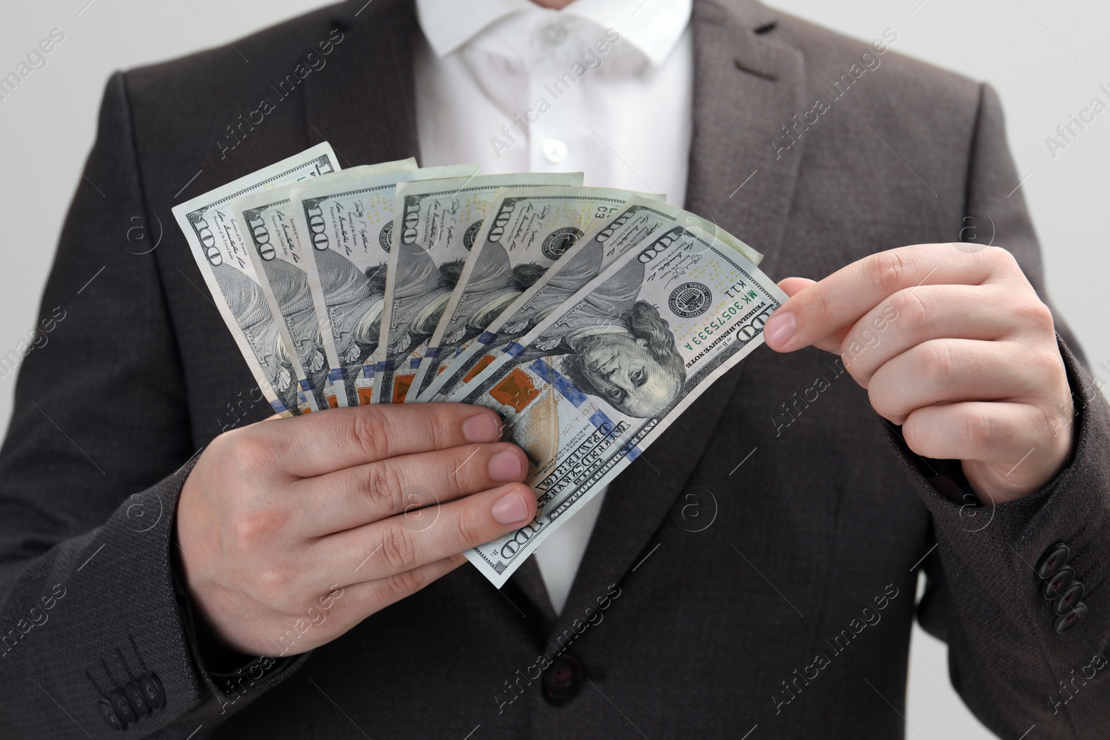 Photo of Man holding money on white background, closeup. Currency exchange