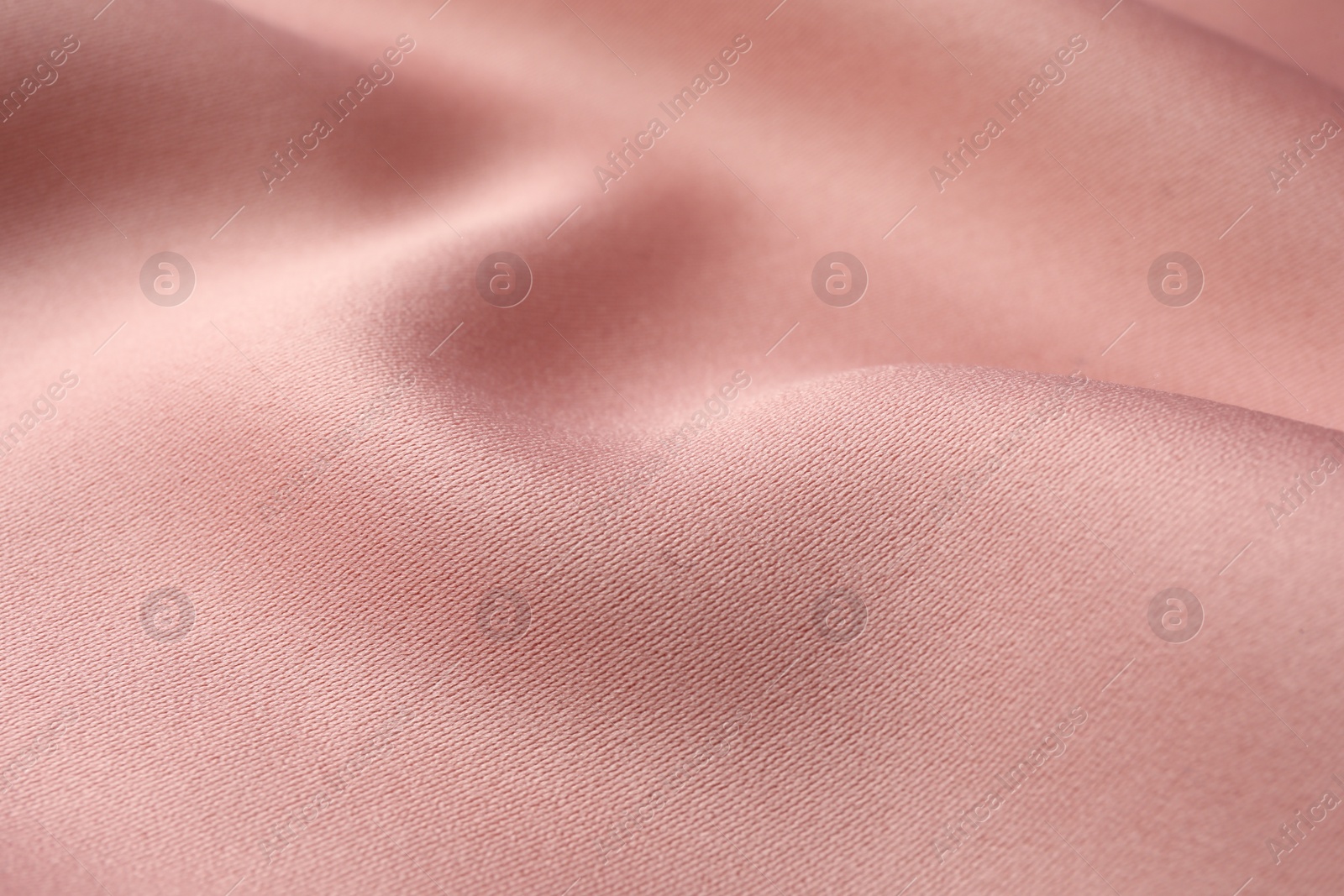 Photo of Texture of pink silk fabric as background, closeup