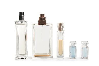 Different perfume bottles on white background