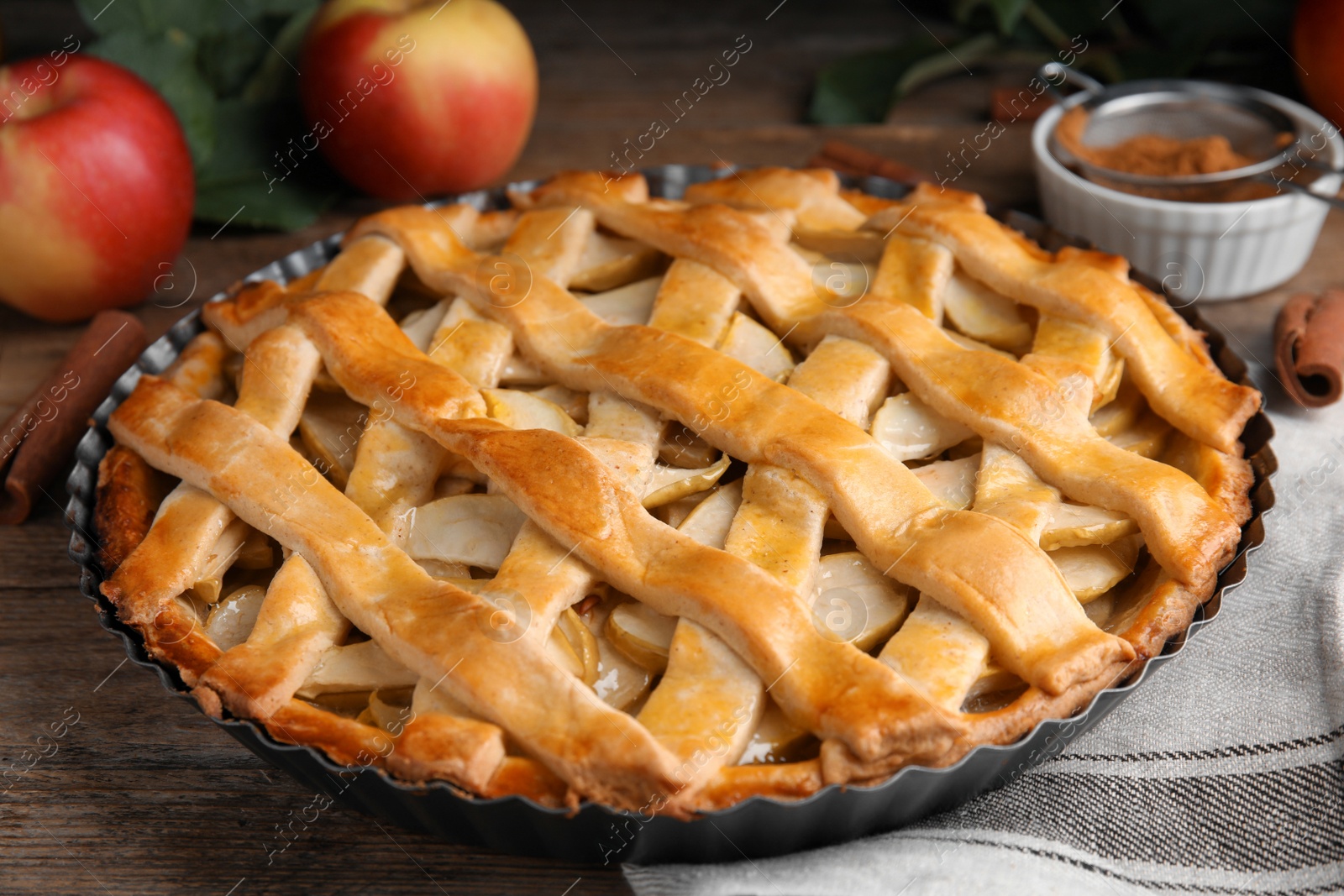 Photo of Delicious traditional apple pie on wooden table, closeup