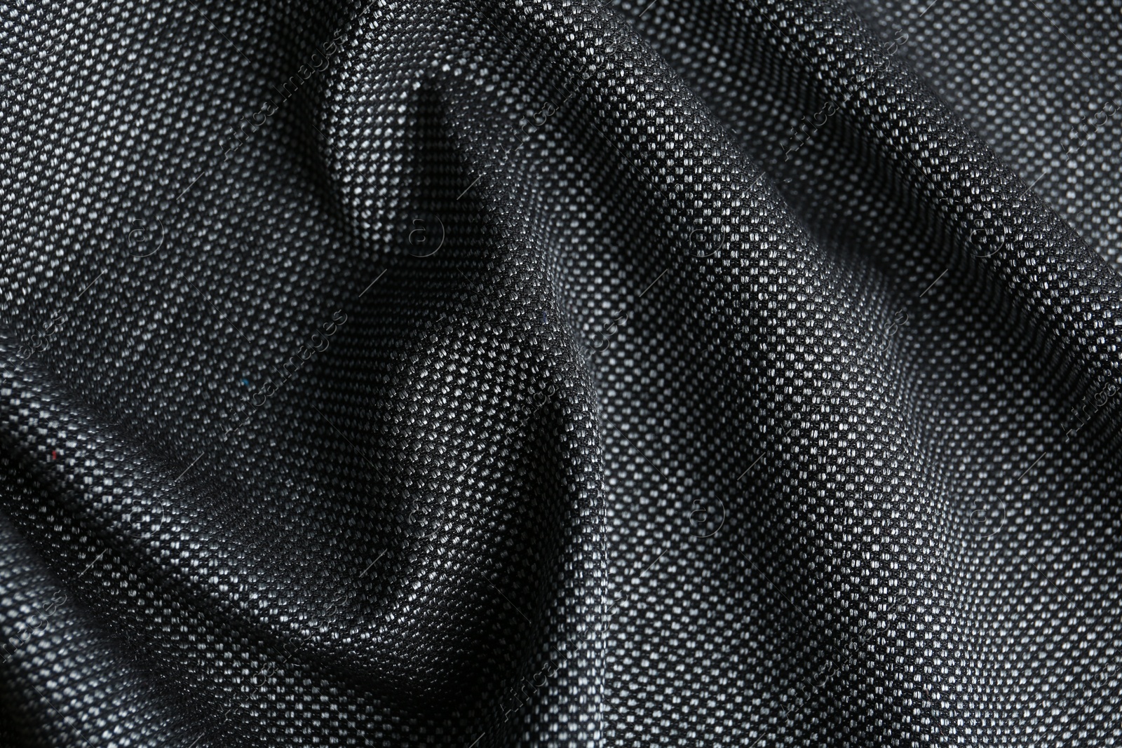 Photo of Texture of dark fabric as background, closeup