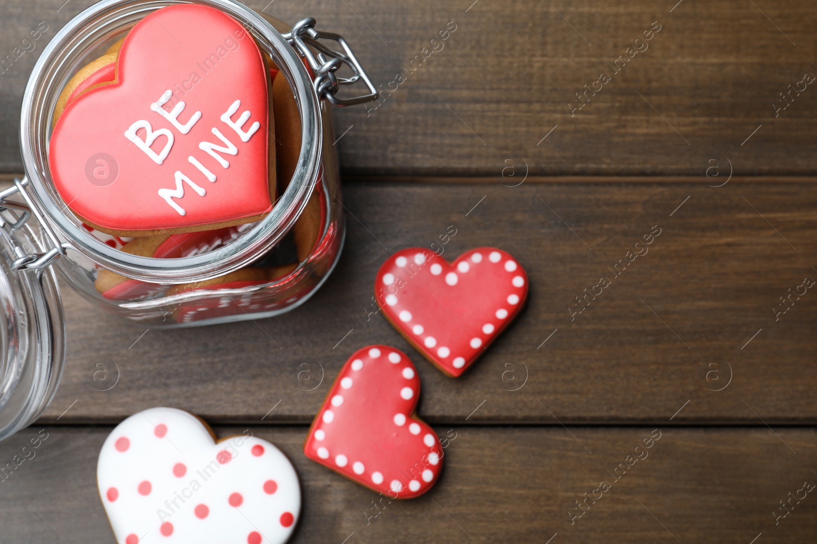 Photo of Delicious heart shaped cookies on wooden table, flat lay. Valentine's Day