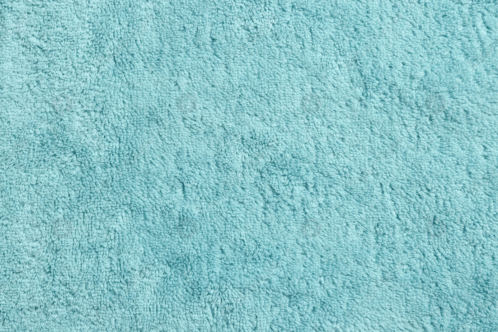 Photo of Soft light blue towel as background, top view