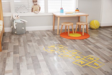 Photo of Yellow hopscotch floor sticker in room at home