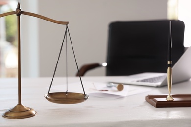 Photo of Scales of justice on desk in notary's office with space for text