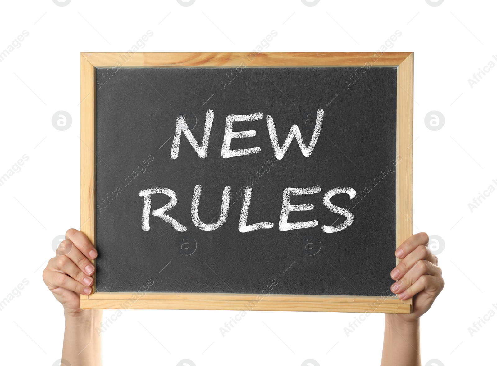 Image of Woman holding blackboard with text NEW RULES on white background, closeup