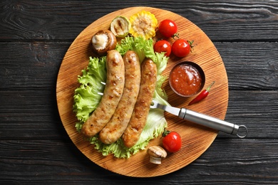 Photo of Delicious meat served for barbecued party on wooden table, top view