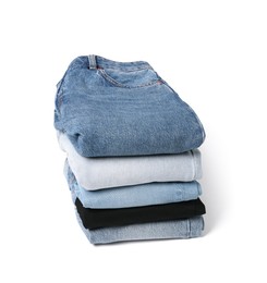 Stack of different folded jeans isolated on white