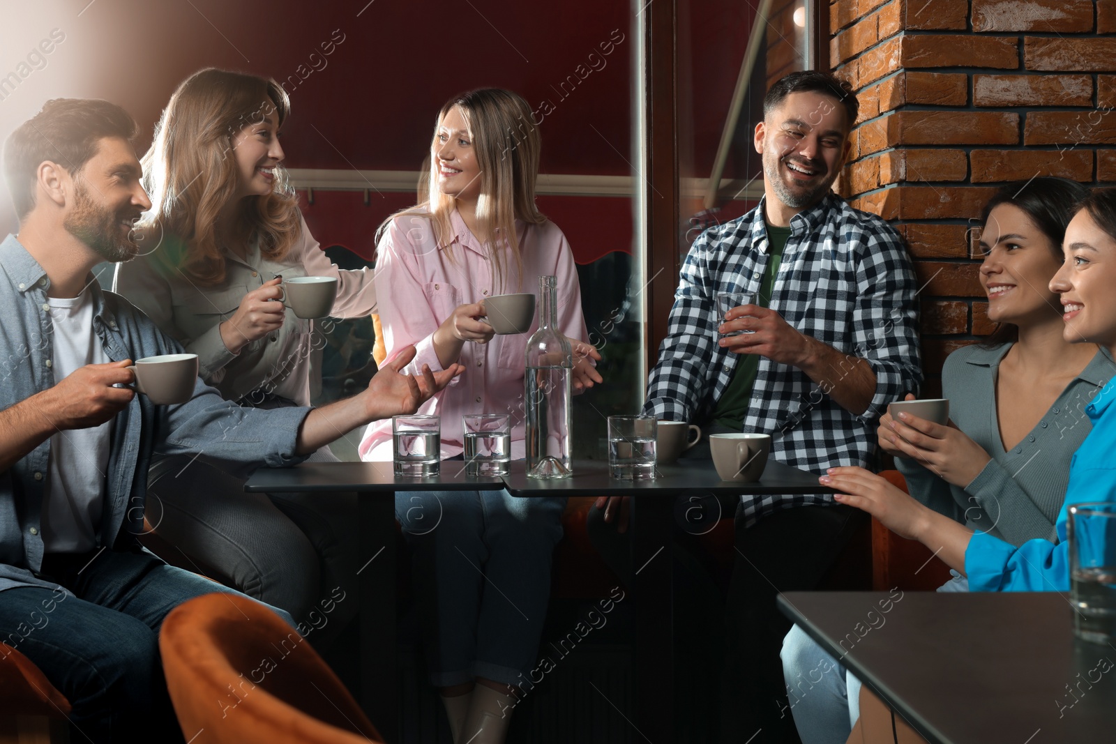 Photo of Friends with coffee spending time together in cafe