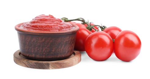 Photo of Organic ketchup in bowl and fresh tomatoes isolated on white. Tomato sauce