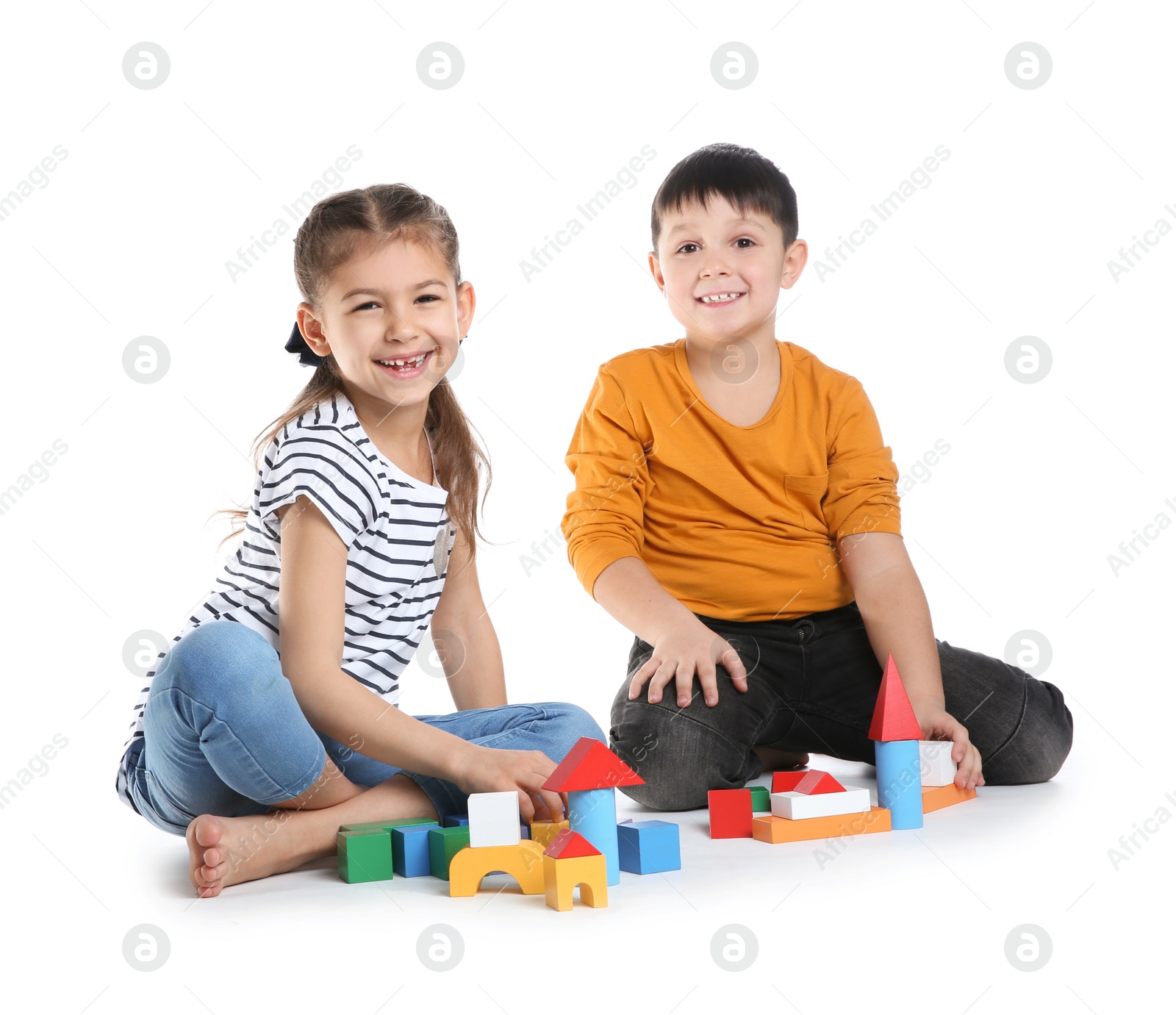 Photo of Cute children playing with colorful blocks on white background