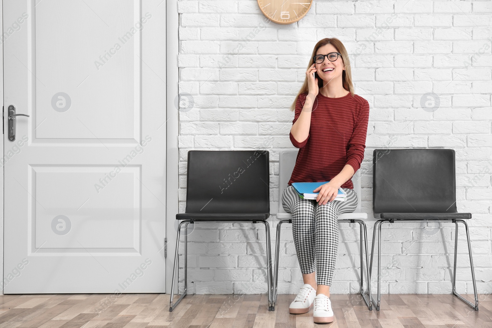 Photo of Young woman waiting for job interview, indoors