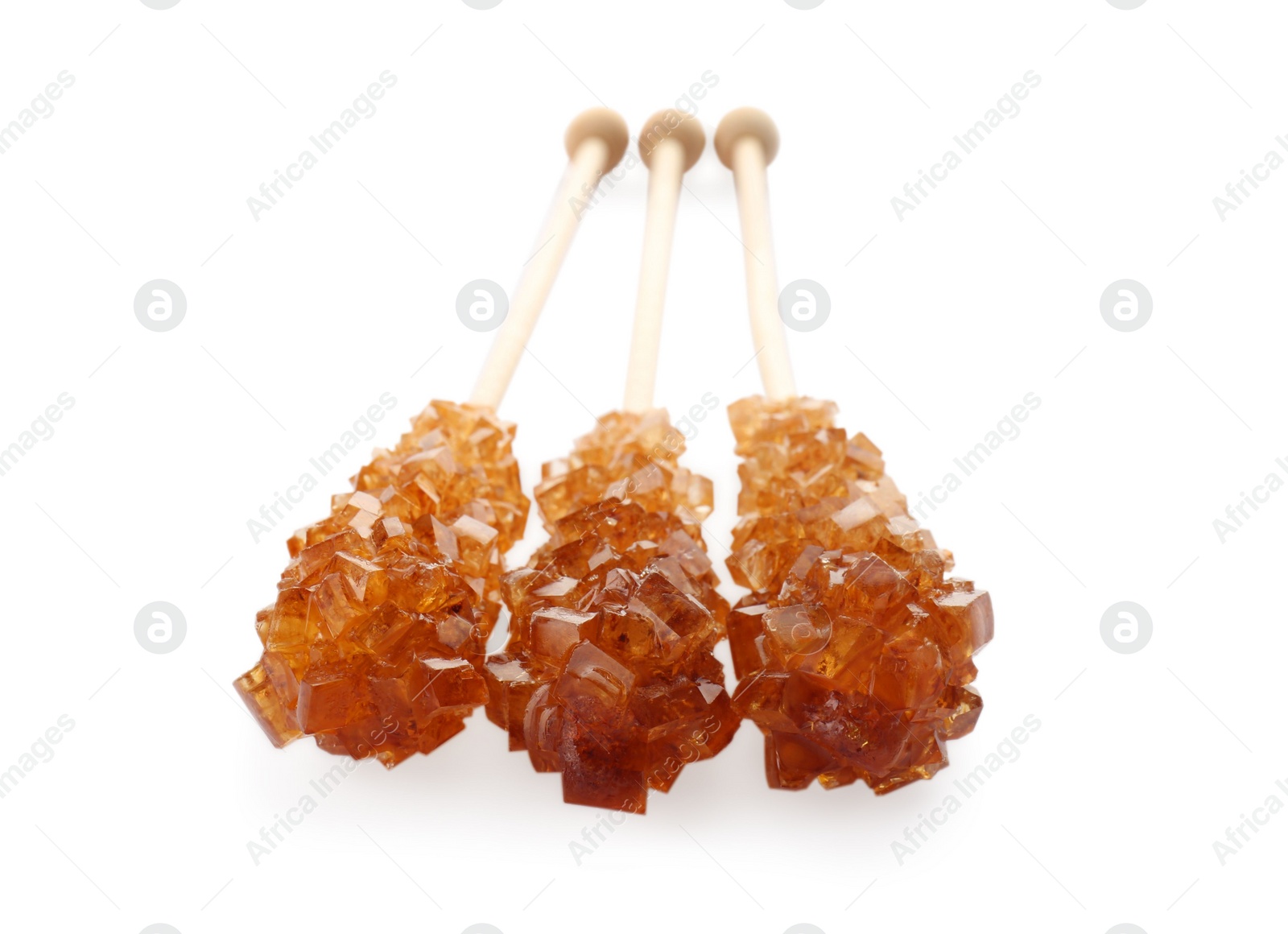 Photo of Wooden sticks with sugar crystals isolated on white. Tasty rock candies