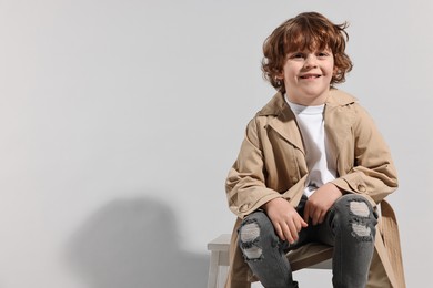 Fashion concept. Stylish boy posing on light grey background. Space for text