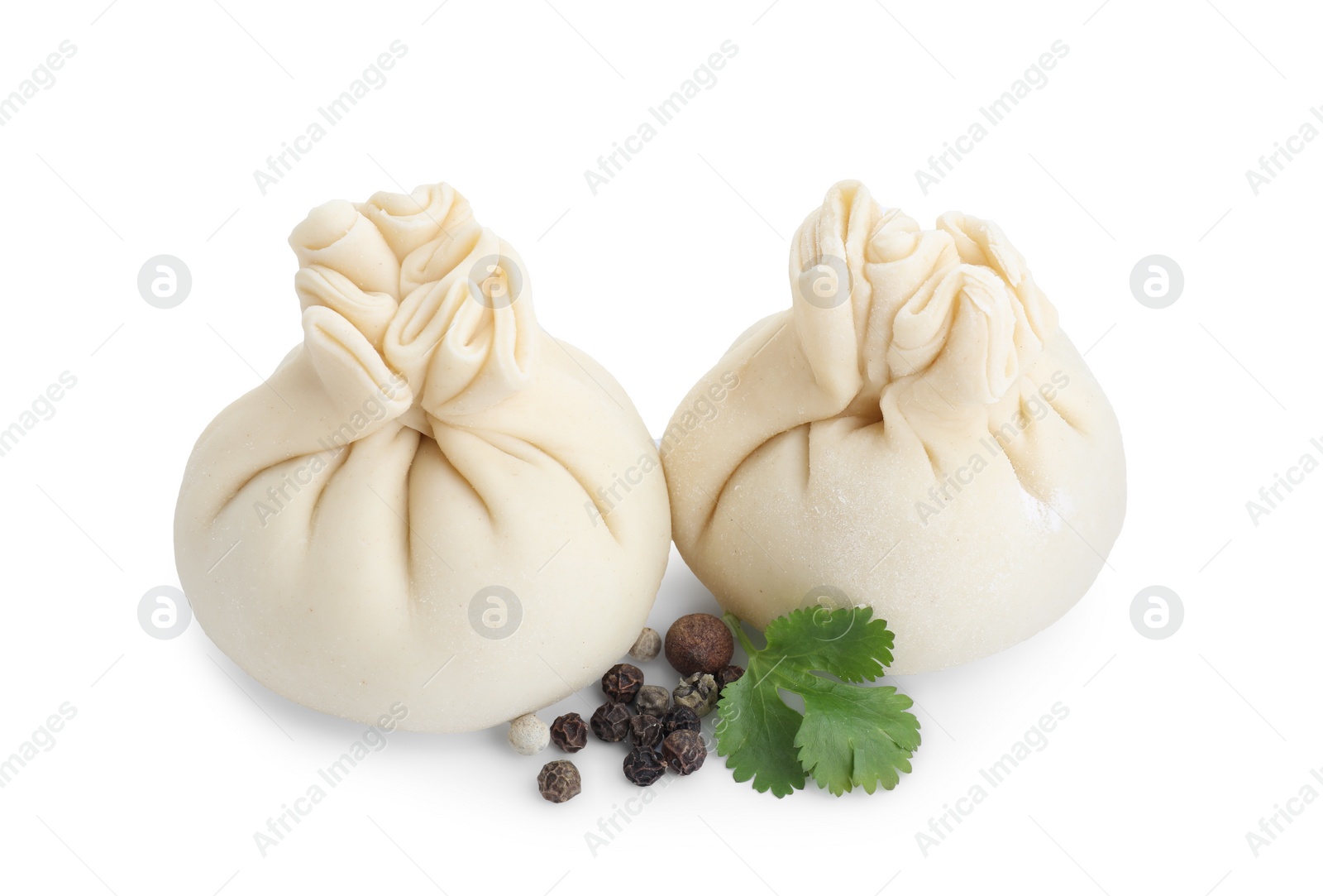 Photo of Uncooked khinkali (dumplings) and spices isolated on white. Georgian cuisine
