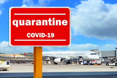 Image of Closure of air traffic during coronavirus outbreak. Airplane and warning sign with inscription QUARANTINE