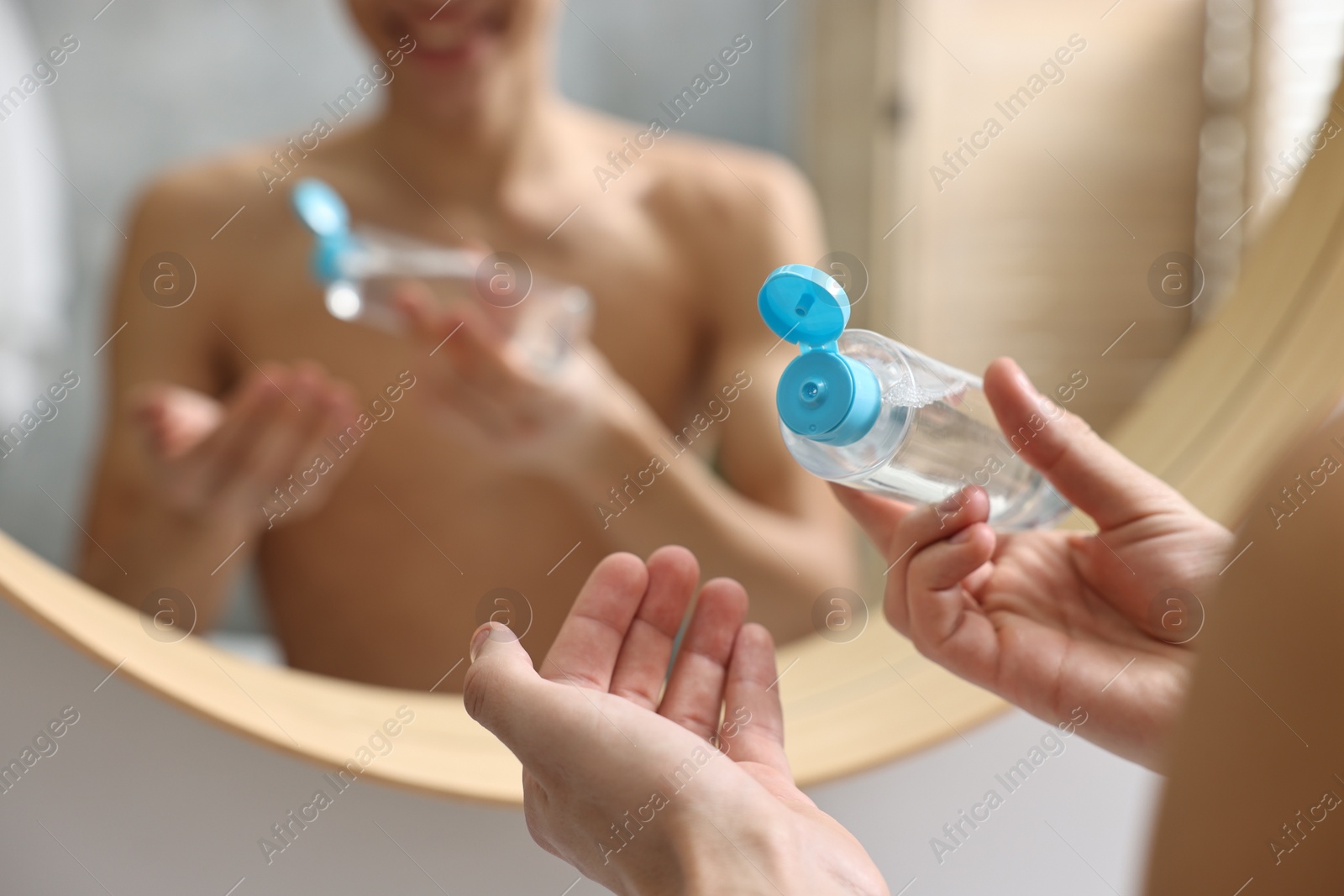 Photo of Man with lotion in bathroom, closeup view