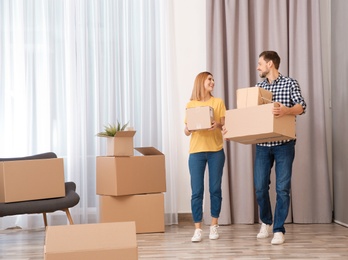 Couple with moving boxes in their new house