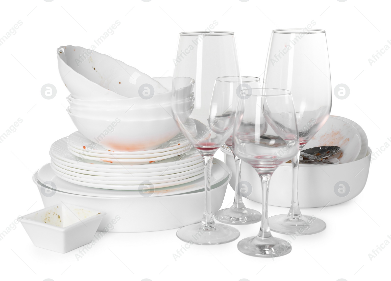 Photo of Many dirty dishes and glasses isolated on white