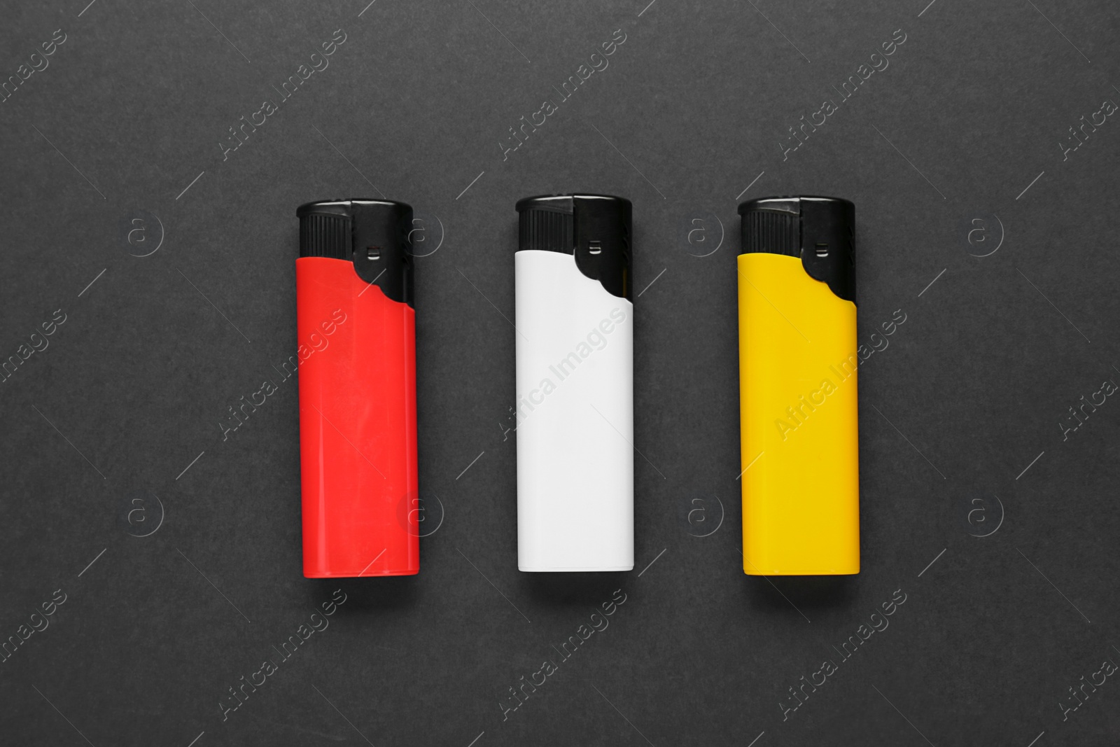 Photo of Stylish small pocket lighters on black background, flat lay